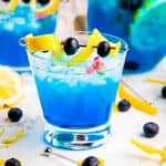 Cocktail glass with Ocean Breeze in it garnished with lemon and blueberry