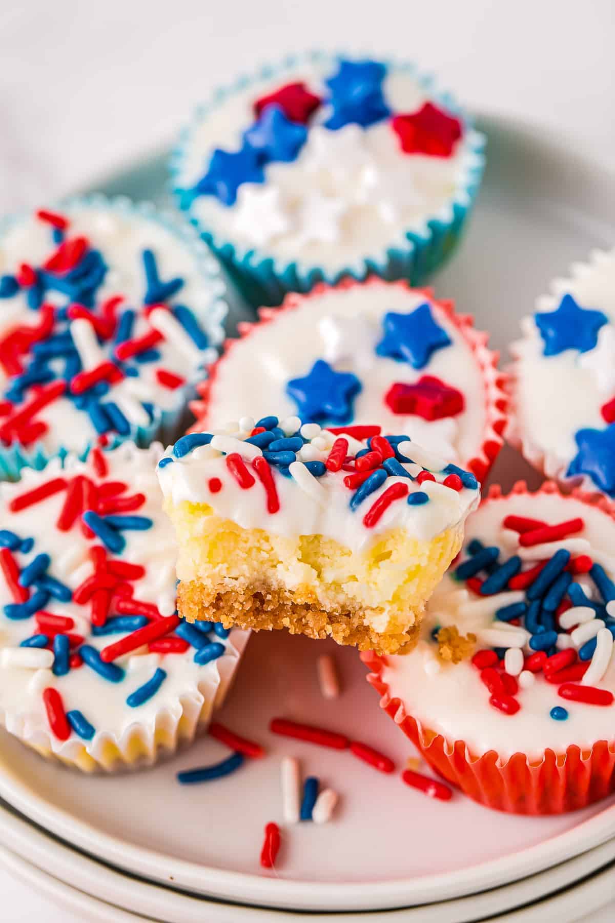 Red White and Blue Mini Cheesecakes stacked on white plate