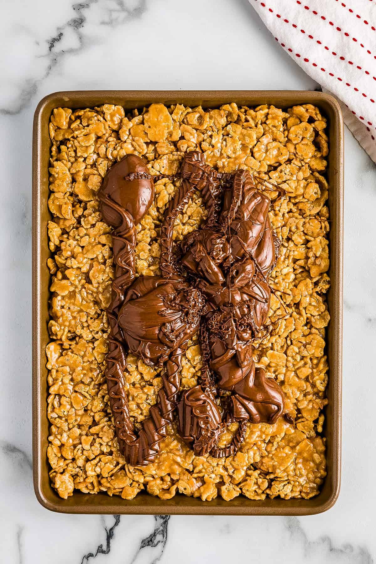 Overhead image of Special K Bars with frosting on top before spreading