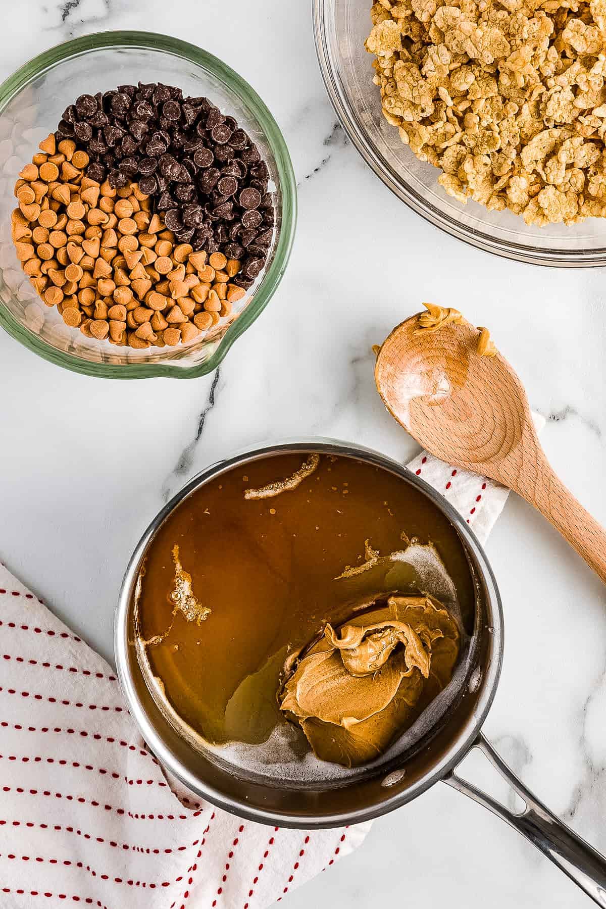 A saucepan with corn syrup mixture plus vanilla and peanut butter