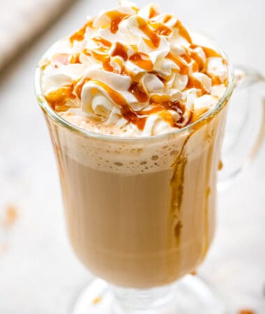 Caramel Latte in a glass with whipped topping and caramel sauce