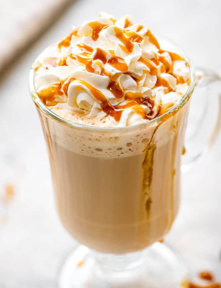 Caramel Latte in a glass with whipped topping and caramel sauce