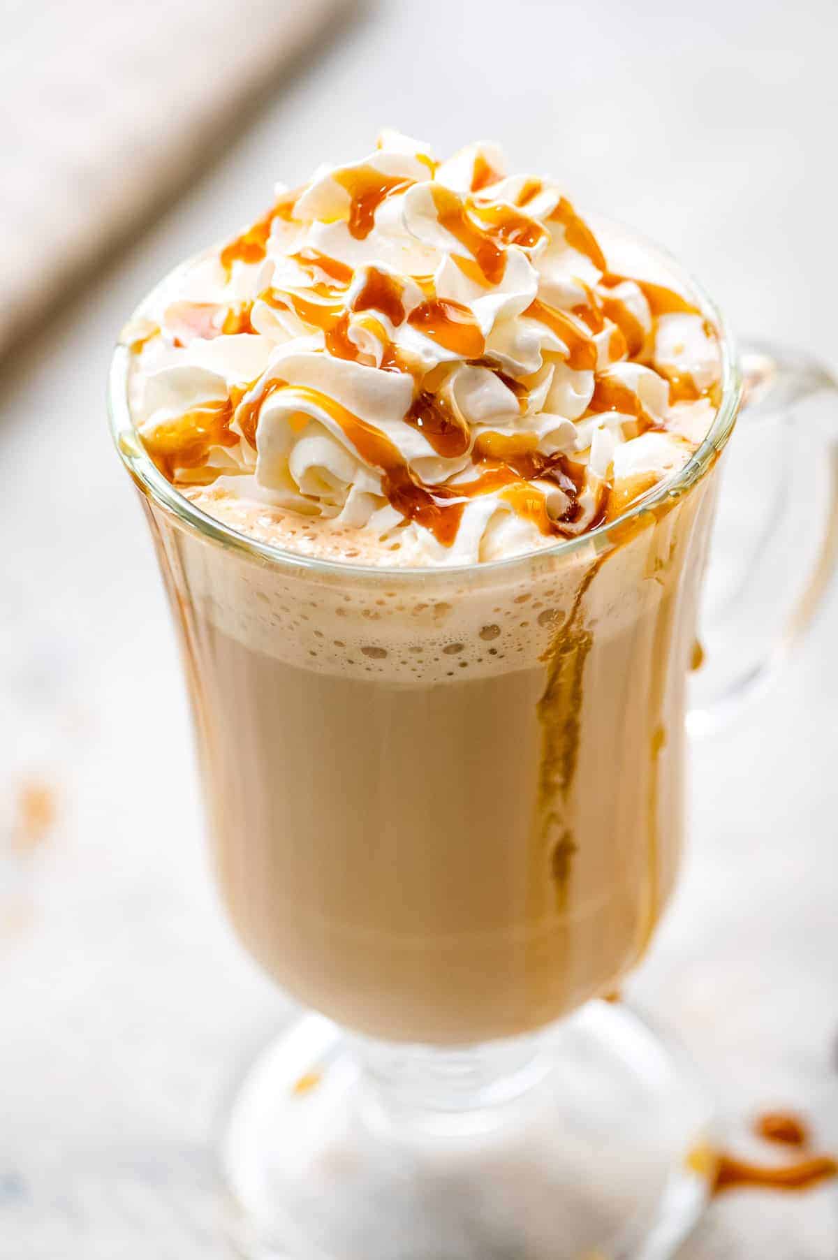 Caramel Latte in a glass with whipped topping and caramel sauce