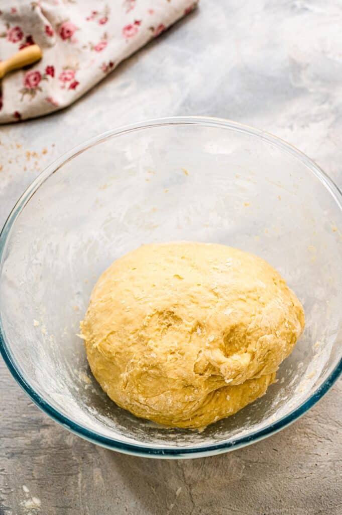 Glass bowl with round of dough in it for rolls