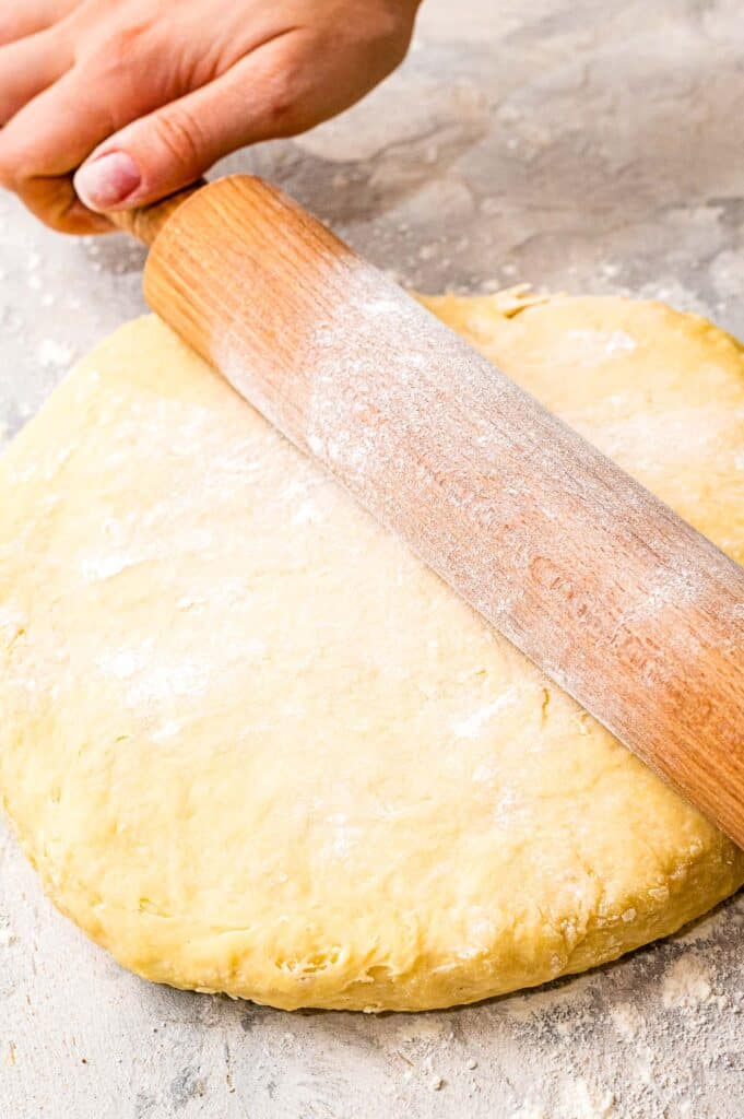 Rolling pin rolling out dough for rolls