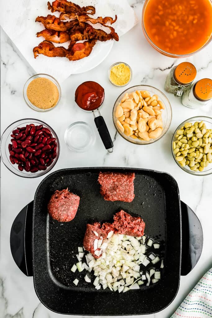 Overhead image of cooking onions and ground beef in skillet