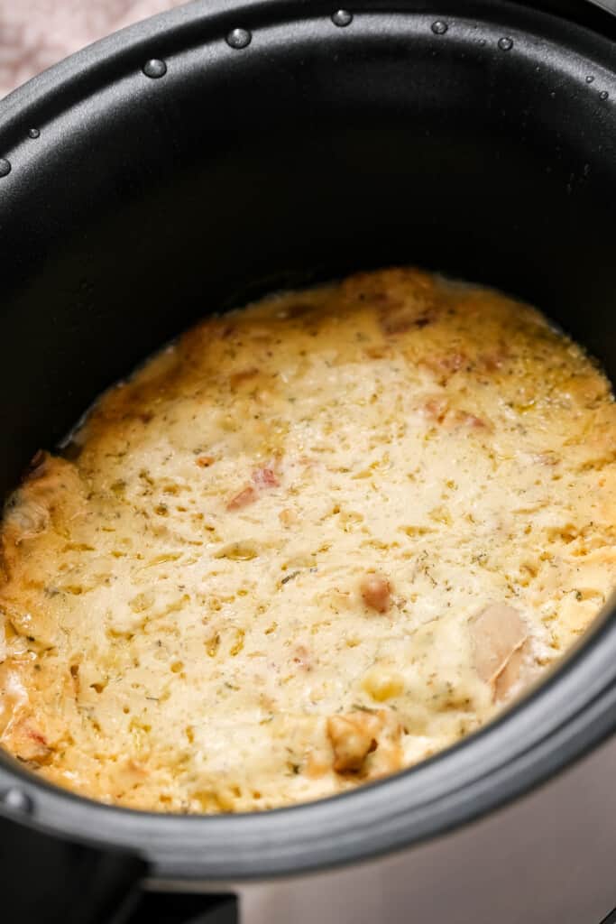 Cooked chicken breasts and cream sauce in crock pot