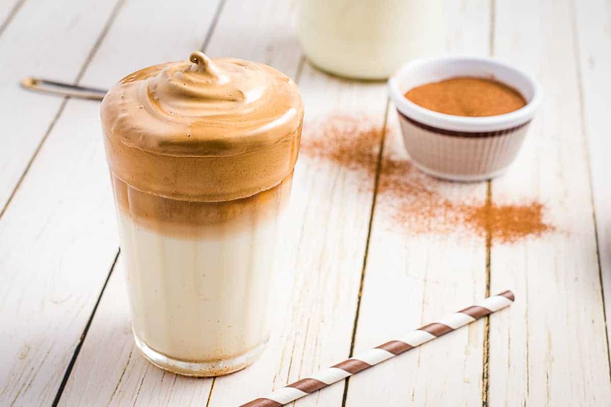 Whipped coffee in a glass on white background