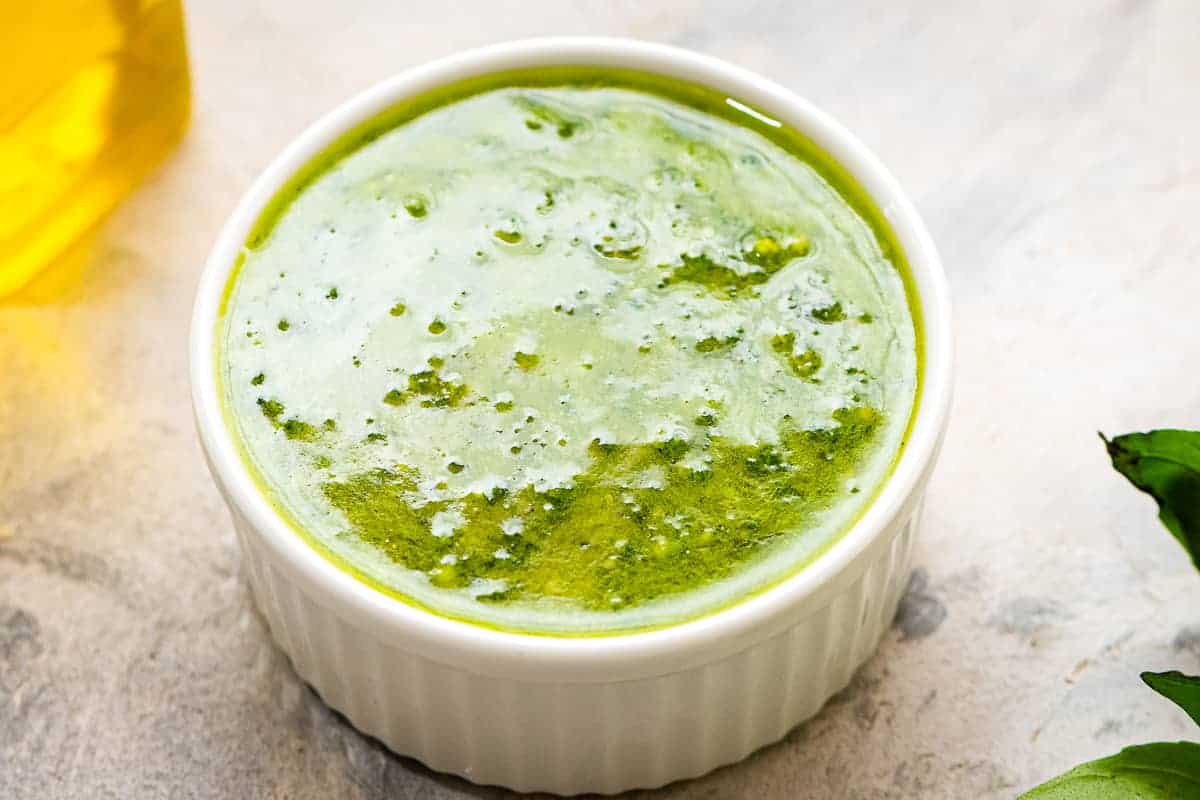 A bowl of pesto on light background