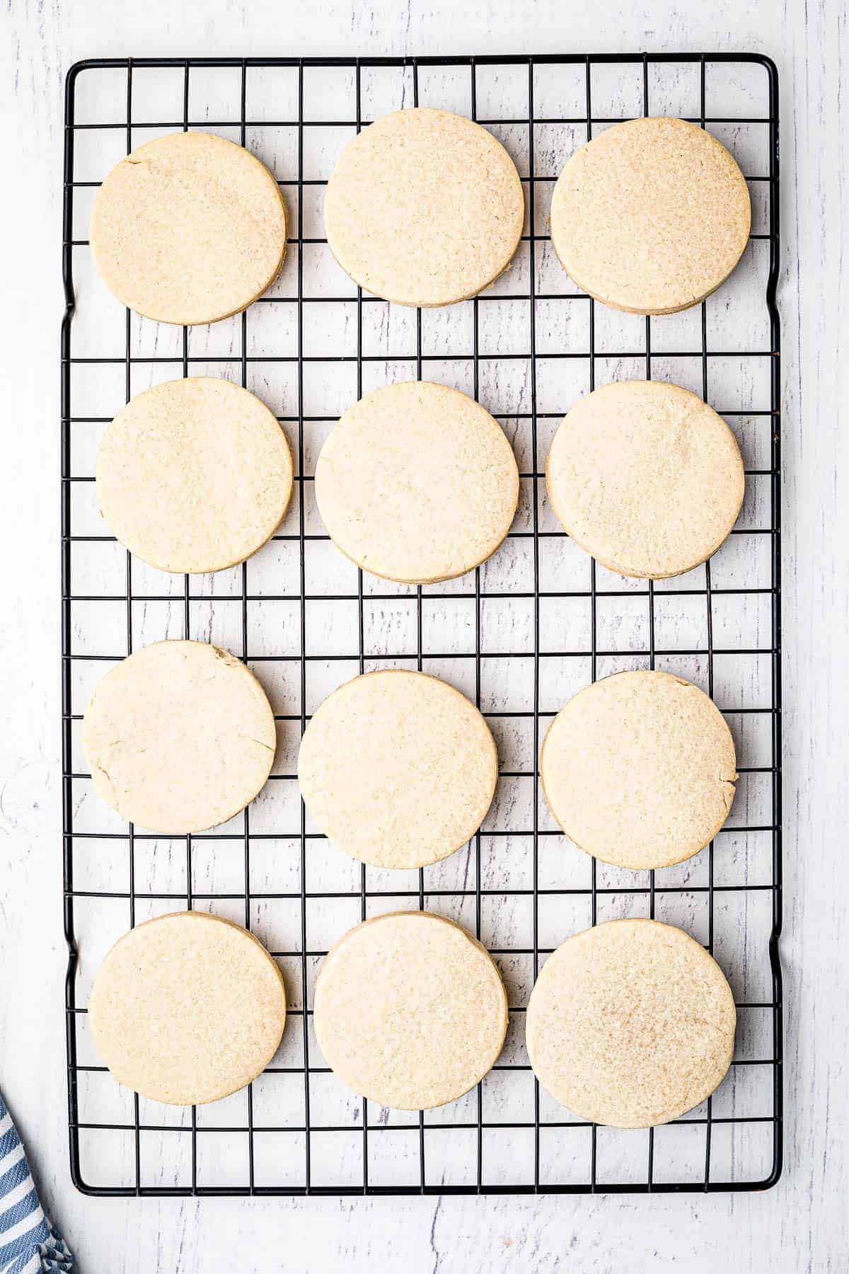 Round sugar cookies cooling on wire rack