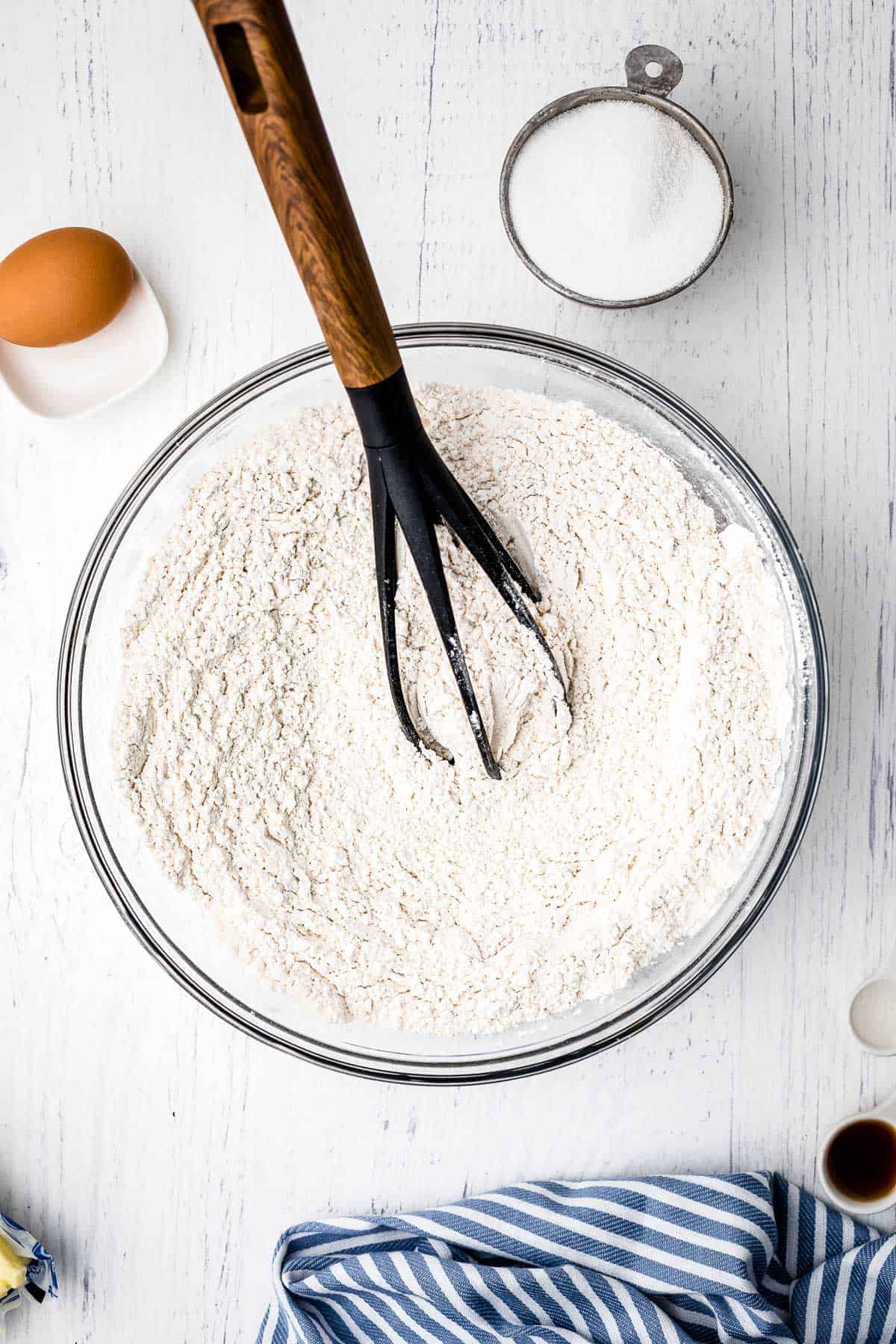 Mixing dry ingredients for sugar cookies with whisk