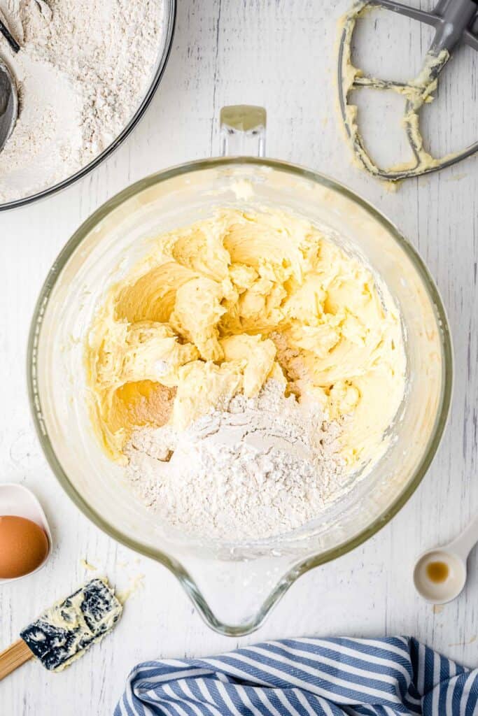 Glass bowl with wet and dry sugar cookie ingredients