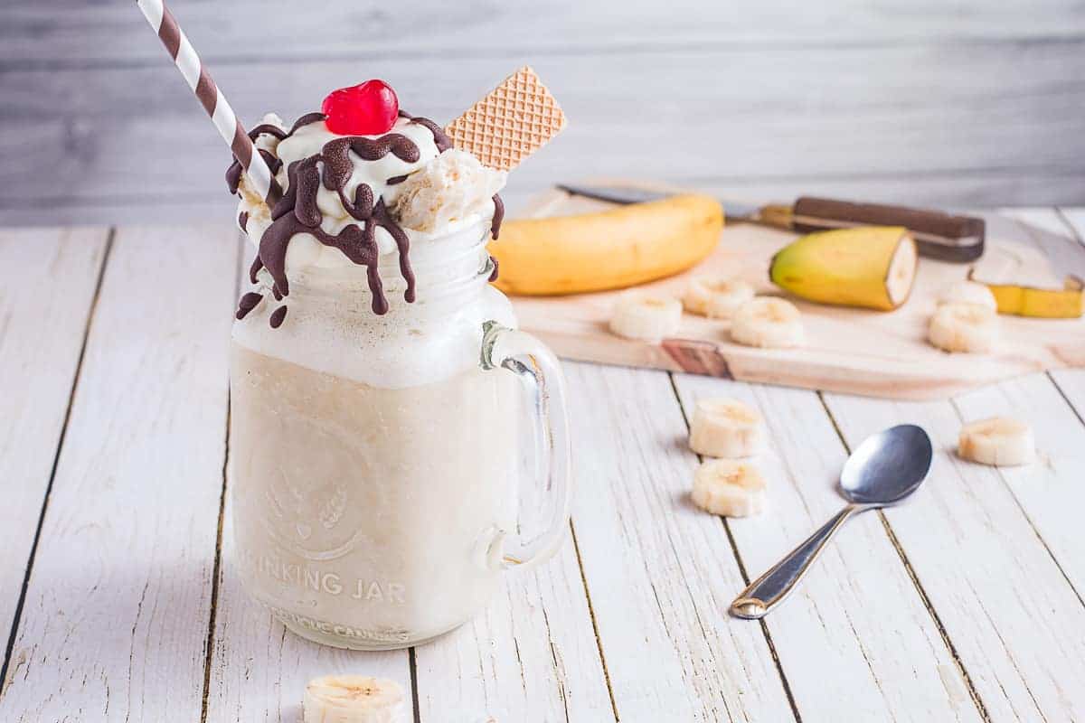 Mason jar mug with banana milk shake in it