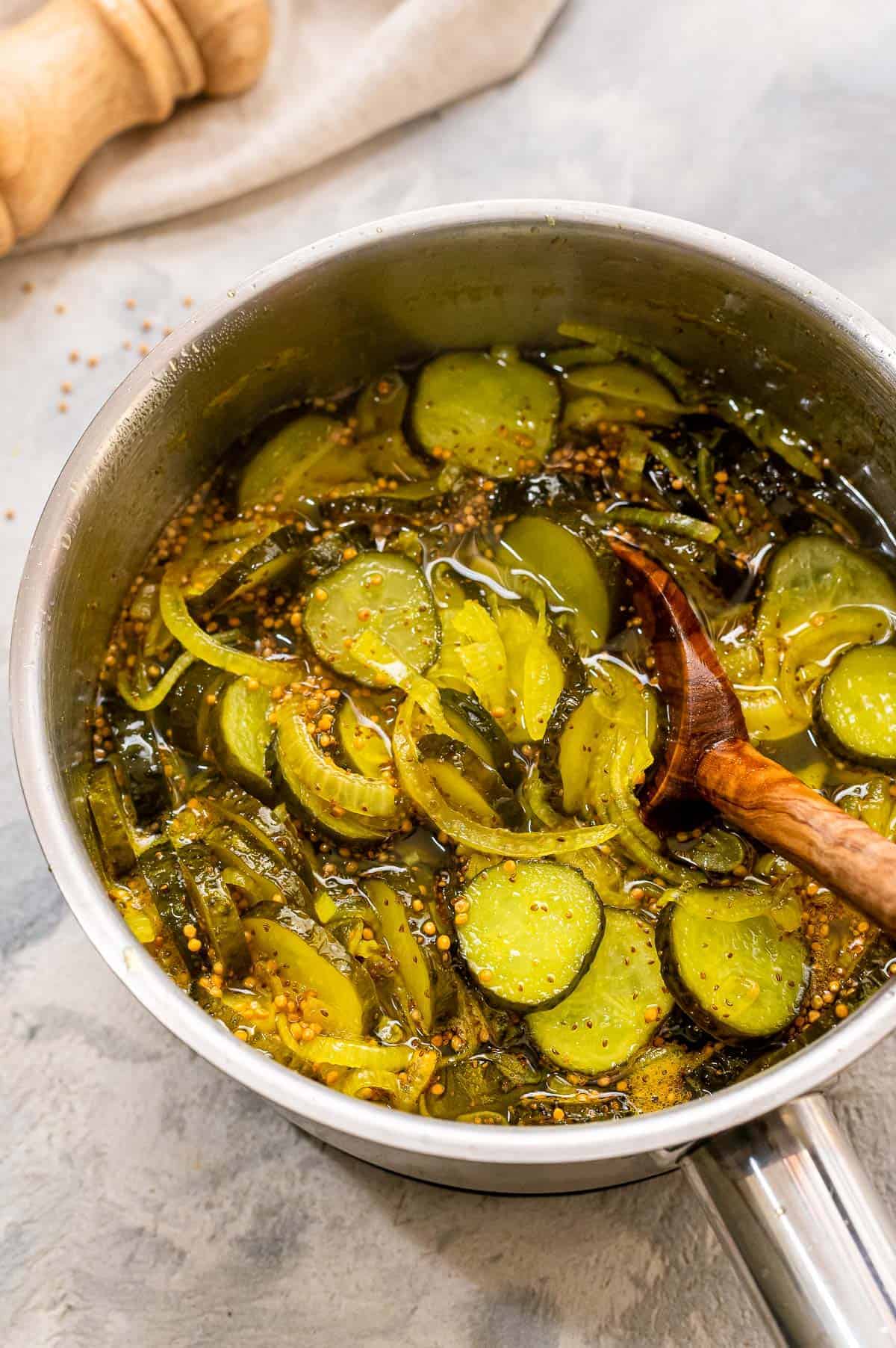 Saucepan with ingredients to make bread and butter pickles