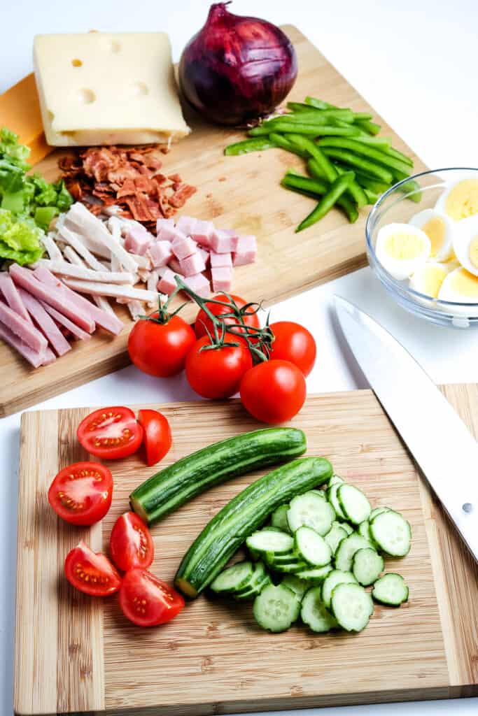 Cutting board with sliced tomato and cucumber