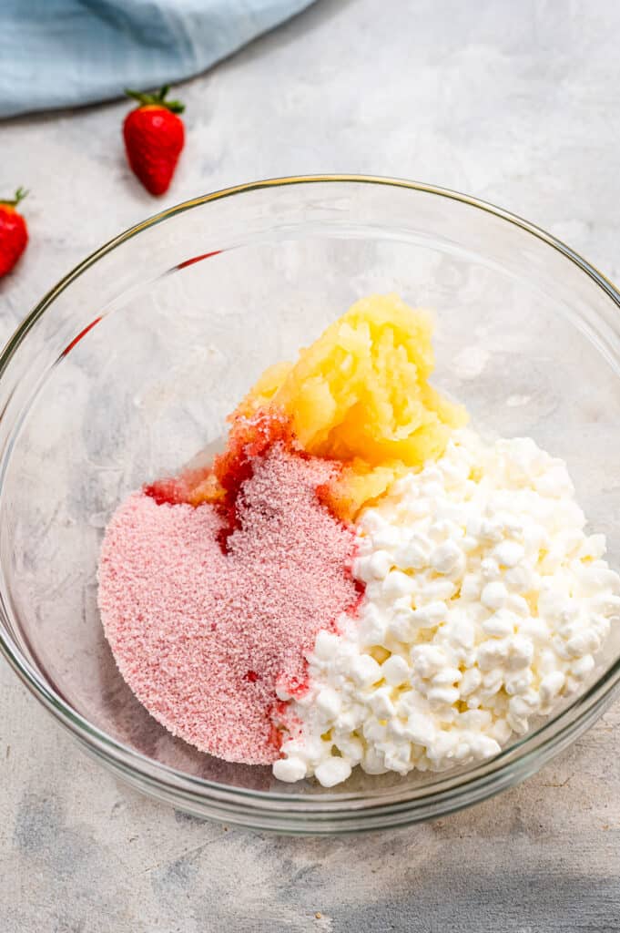 Glass bowl with ingredients to make cottage cheese salad