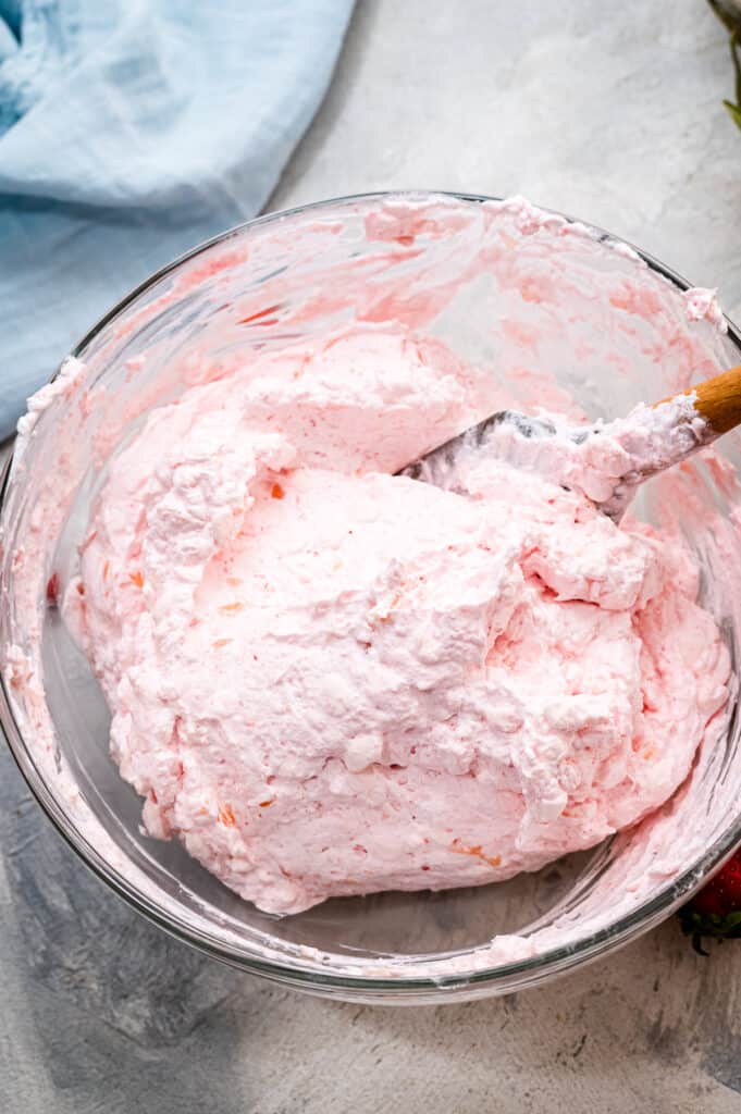 Mixing Cool Whip and cottage cheese for salad