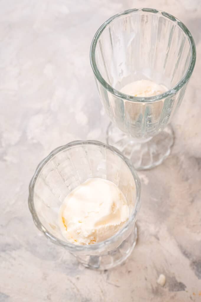 Overhead image of glasses with a scoop of vanilla ice cream