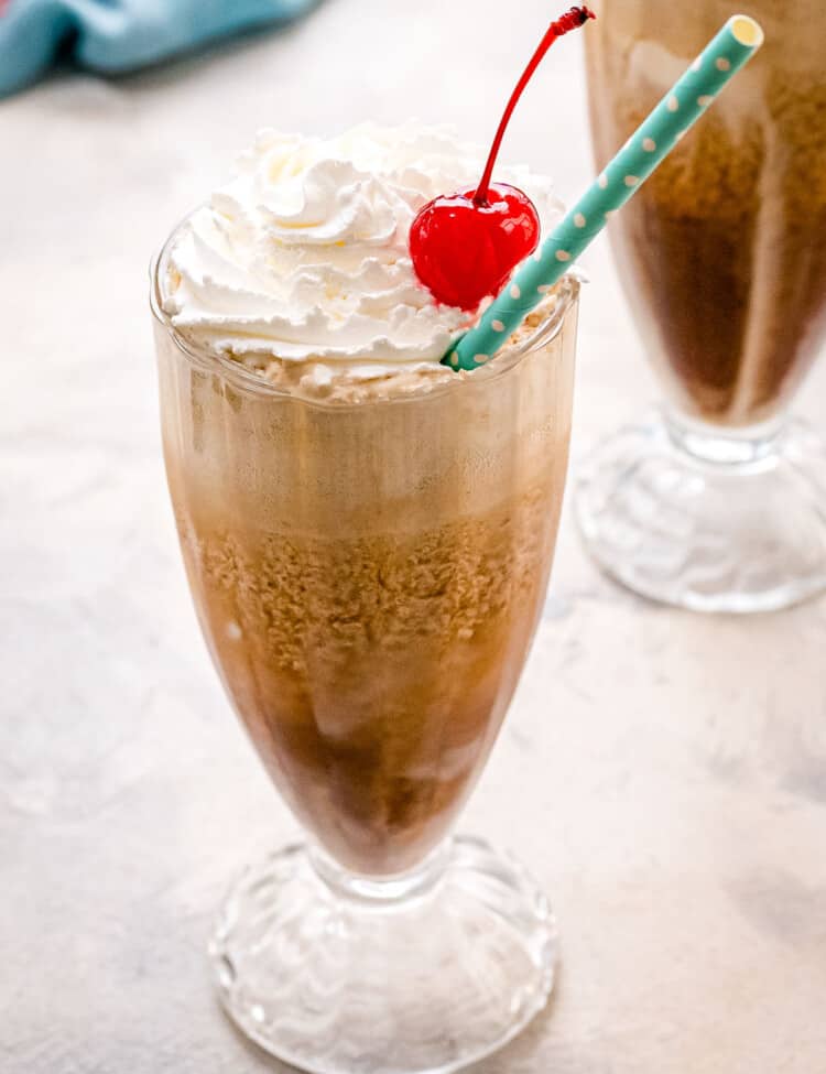 Homemade root beer float with whipped cream and cherry on top