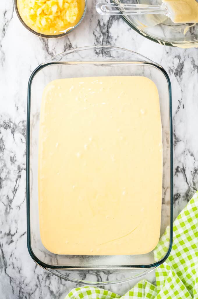 Cake mix poured into a glass baking dish