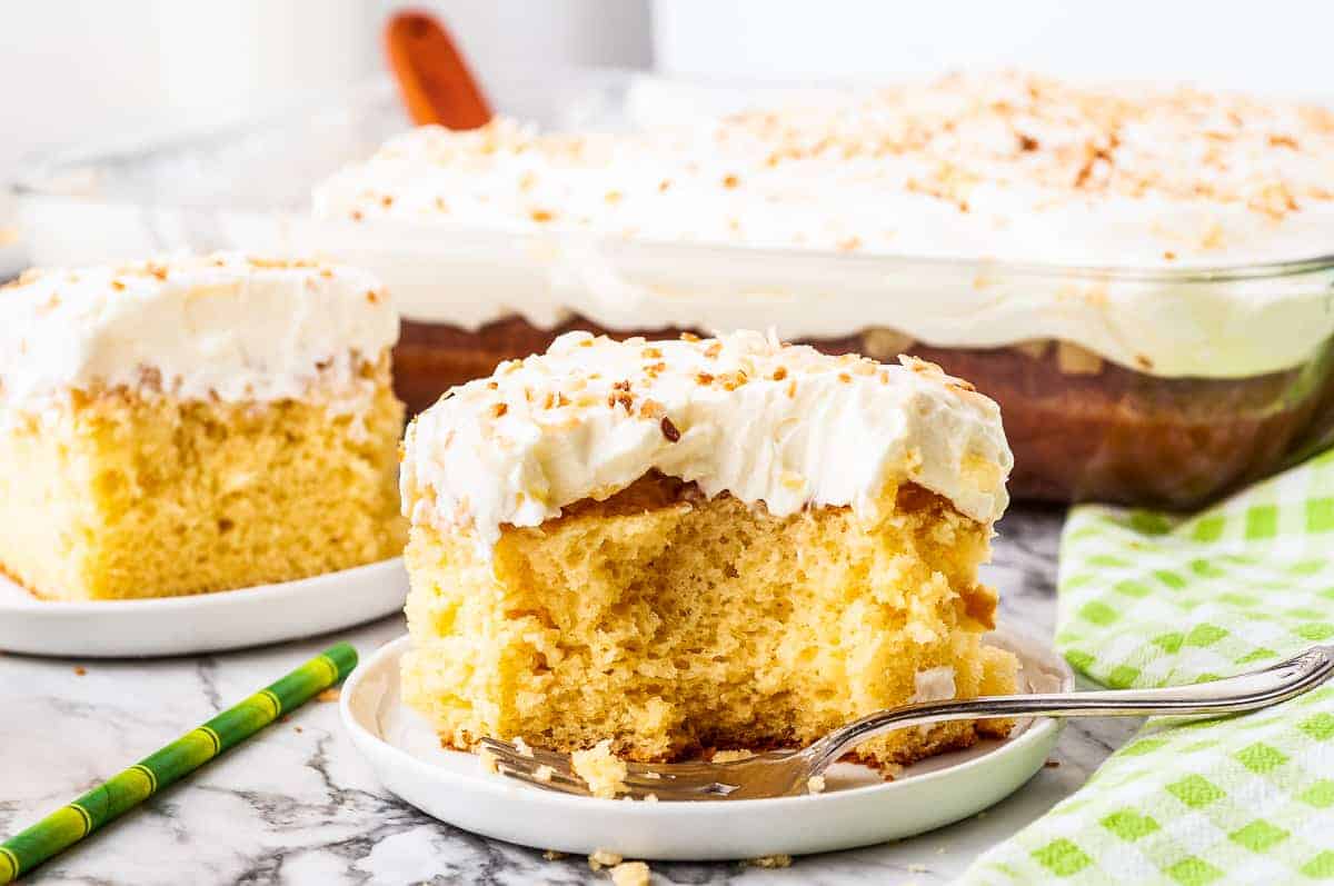 White plate with pineapple cake piece and fork