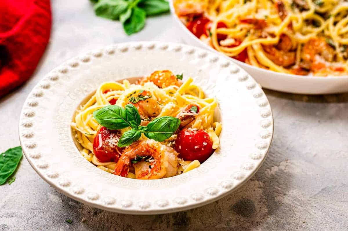 White bowl with shrimp pasta in it