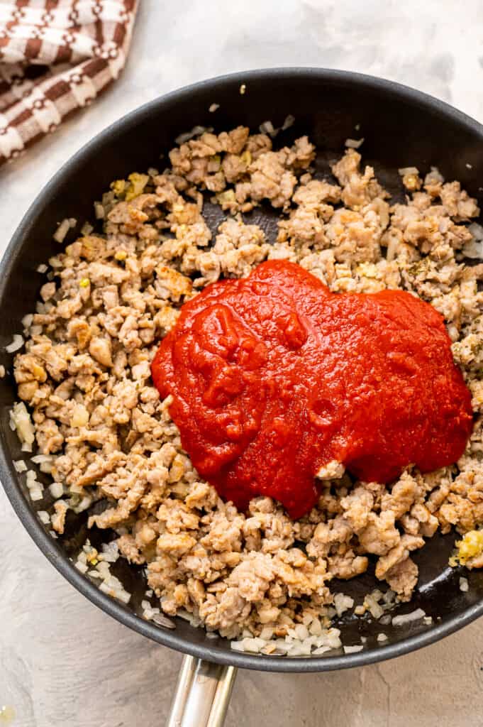 Skillet with ground sausage and marinara sauce