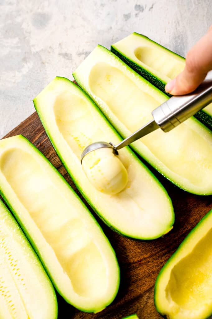 Scooping out the inside of a zucchini with melon baller