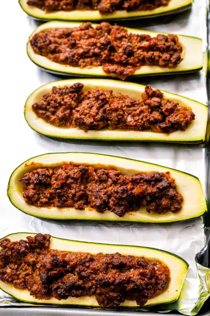 Zucchini with taco meat mixture in them after baking