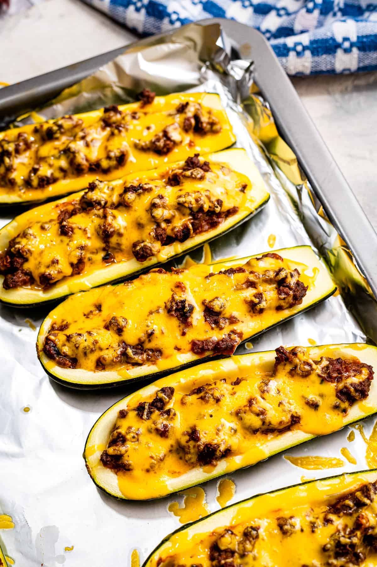 Taco Stuffed Zucchini Boats on a foil lined baking sheet