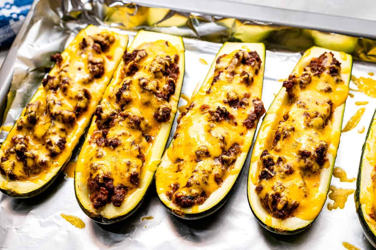 Foil lined pan with baked Taco Stuffed Zucchini Boats