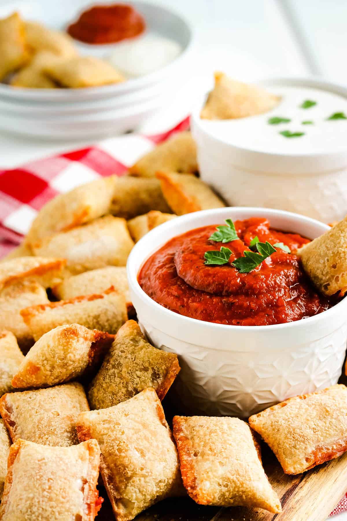 Air Fryer Pizza Rolls on cutting board with marinara 