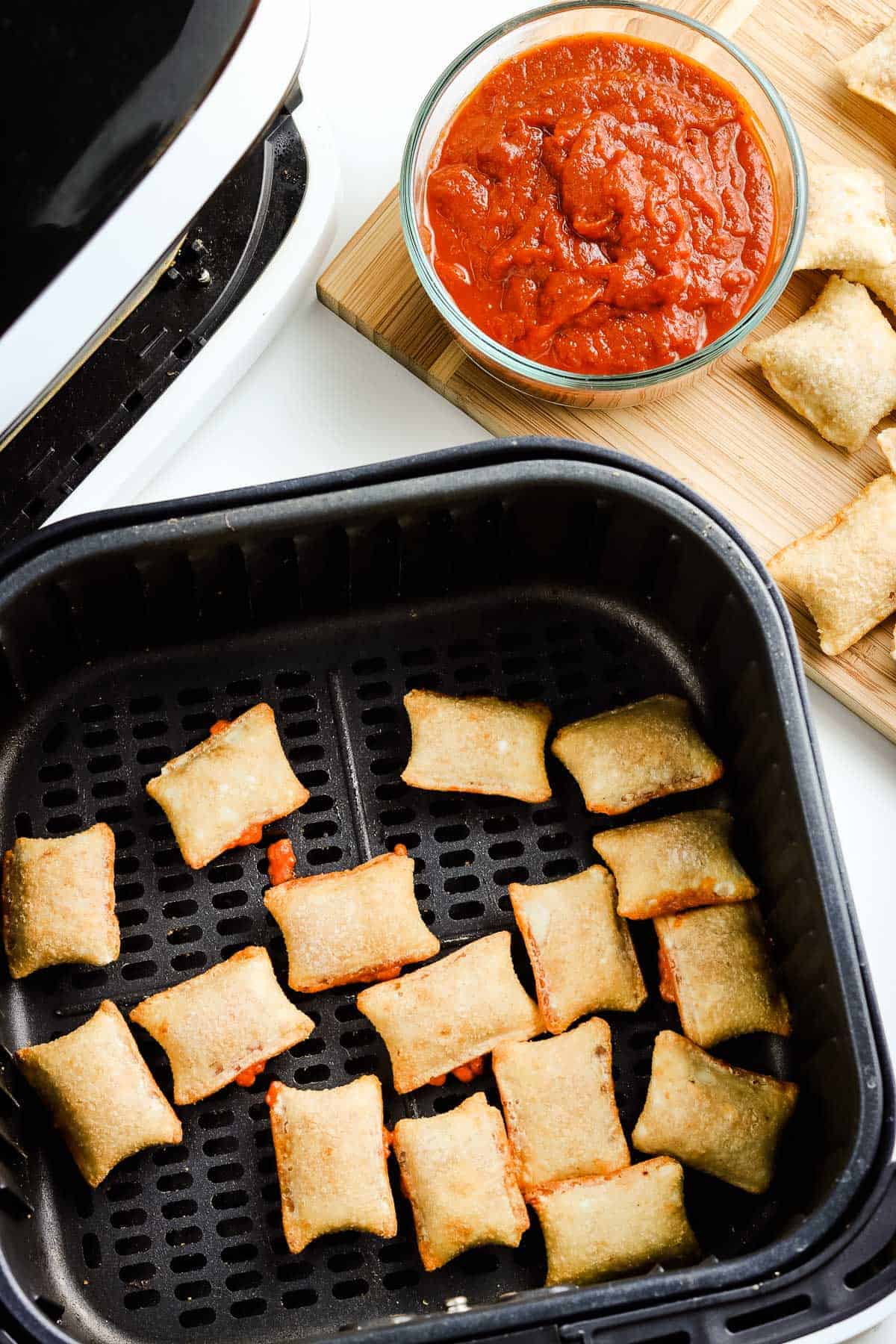 Cooked pizza rolls in air fryer basket