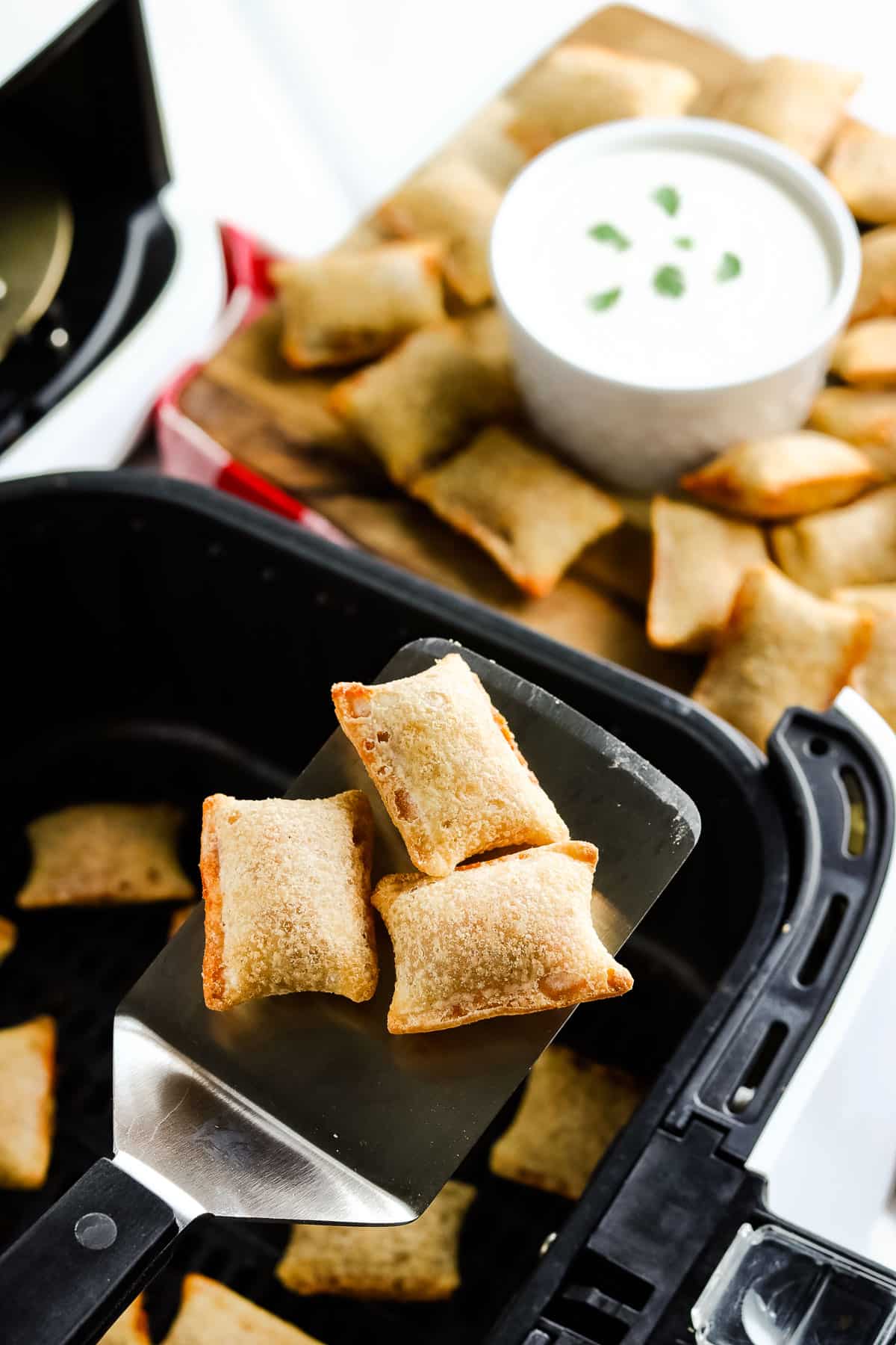 Spatula with three pizza rolls on it