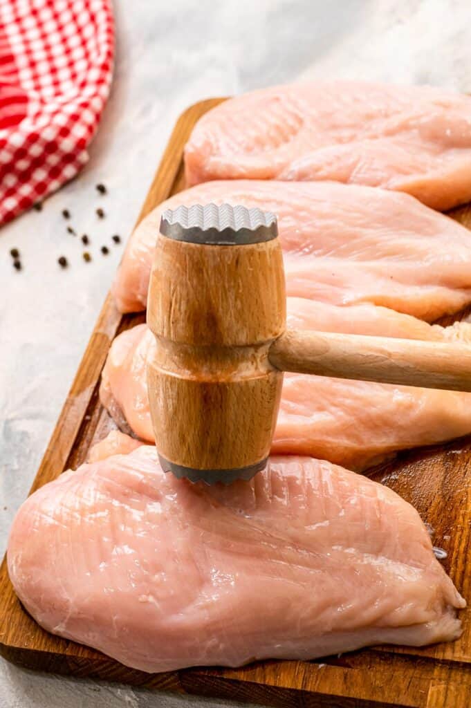 Meat mallet pounding chicken breasts