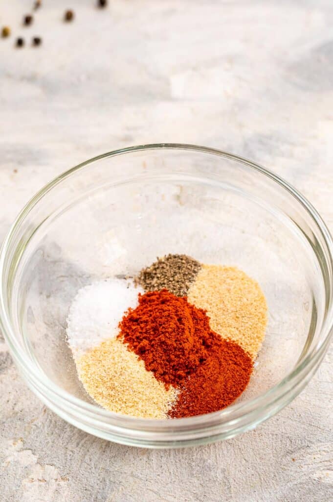 Glass bowl with seasoning for chicken