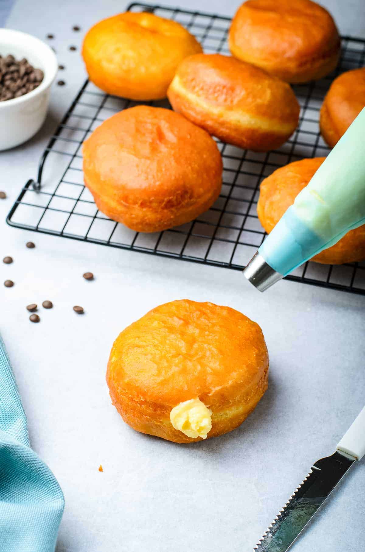 Donut being filled with custard