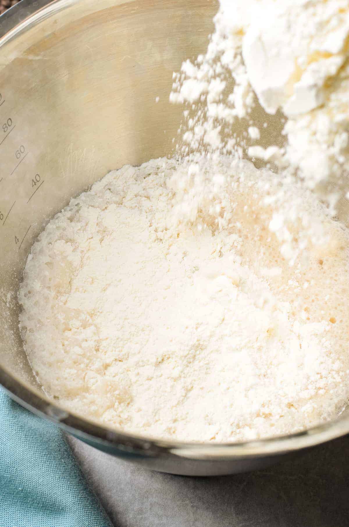 Mixing flour in mixing bowl for donuts