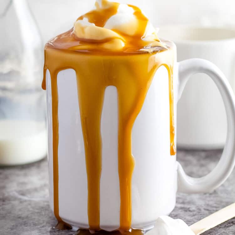 Caramel Macchiato in white mug on gray background