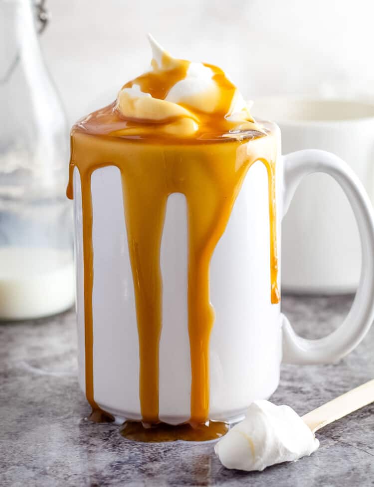 Caramel Macchiato in white mug on gray background