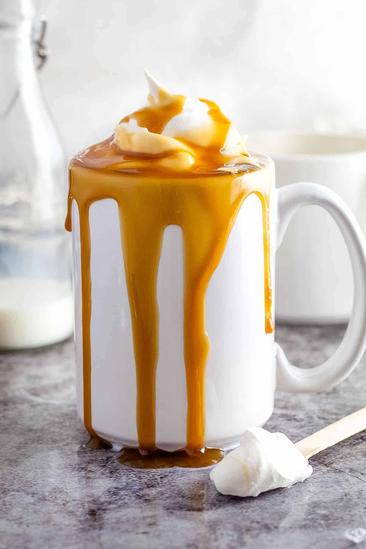 Caramel Macchiato in white mug on gray background