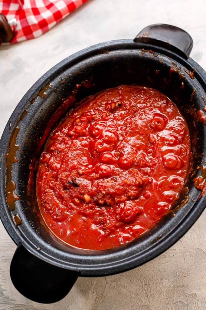 Black slow cooker with spaghetti sauce