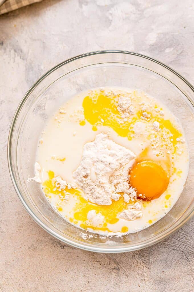 Pancake batter ingredients in glass bowl