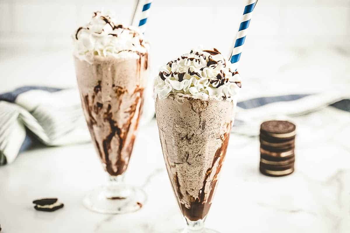 Oreo milkshake in old fashioned glass with paper straw