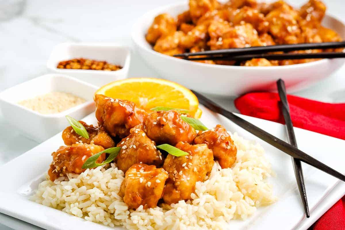 Plate of rice topped with orange chicken