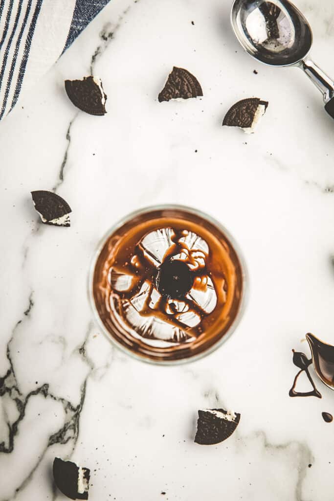 Milkshake glass with sides drizzled with chocolate syrup