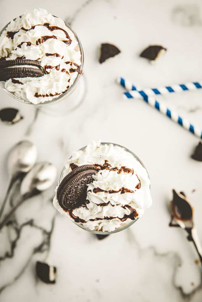 Overhead image of milkshake topped with whipped cream and an Oreo