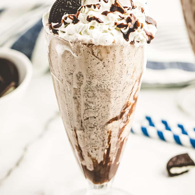 Milkshake glass with oreo milkshake in it