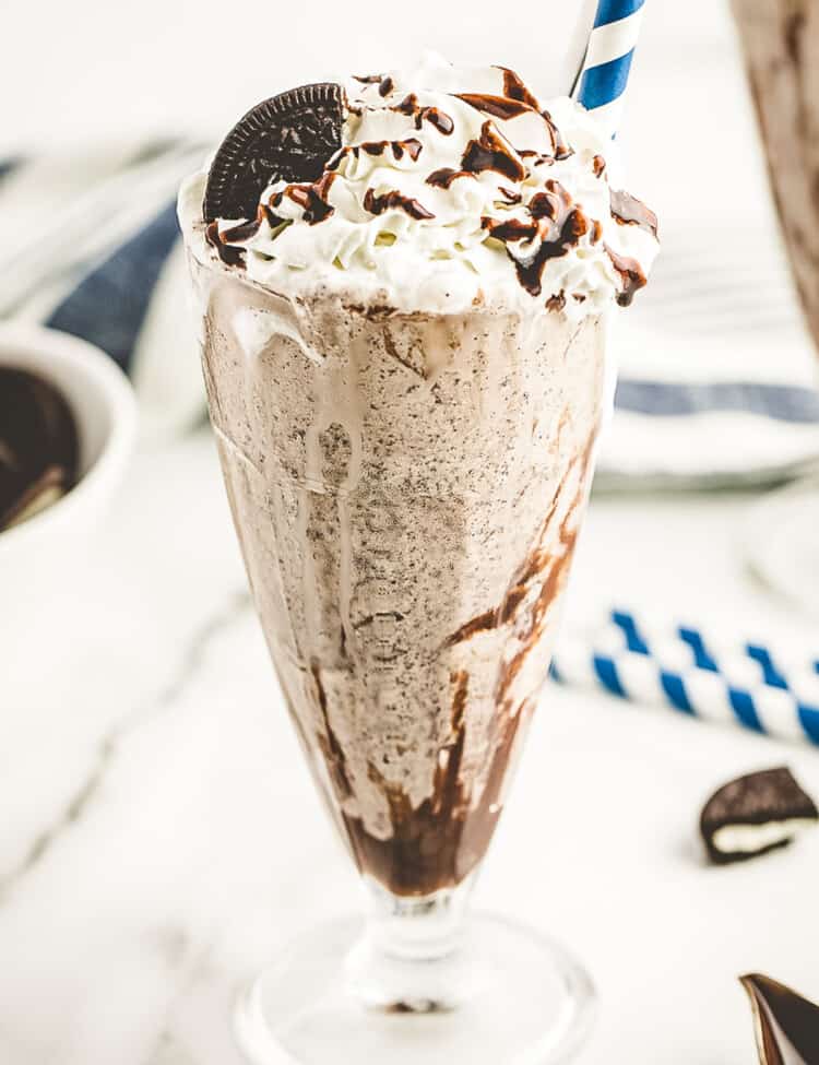 Milkshake glass with oreo milkshake in it