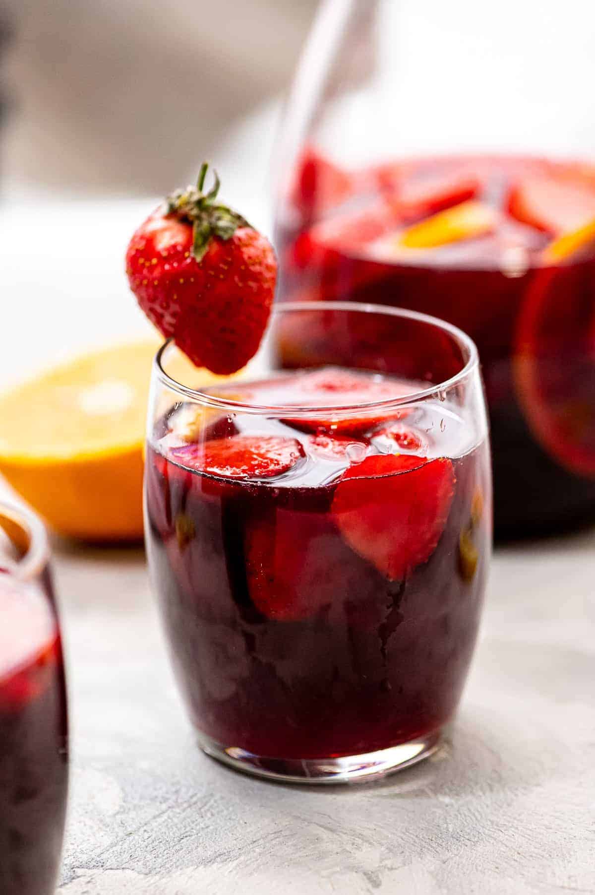 Glass of Red Sangria garnished with a strawberry